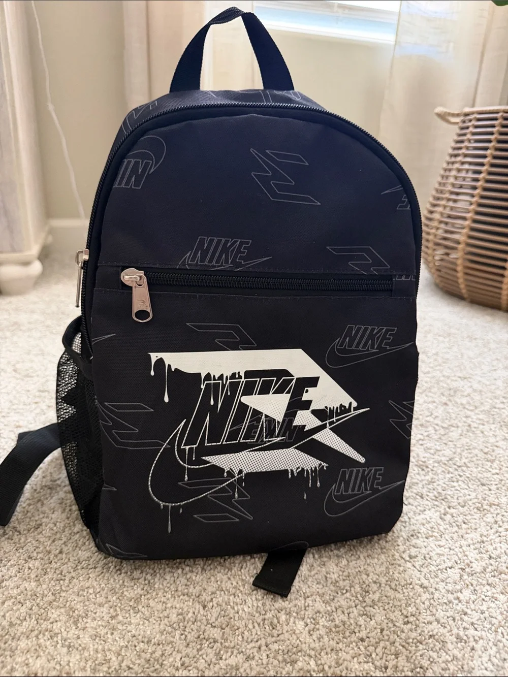 Nike Black Backpack with White Drip Logo.